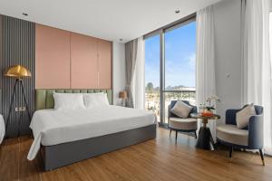 a hotel room with a bed and a large window at Lavender Hotel Vân Đồn in Tài Xá
