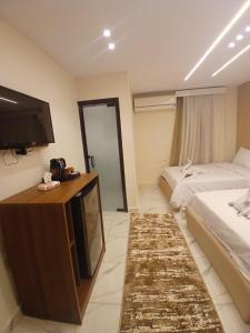 A bed or beds in a room at Inside Pyramids Hotel