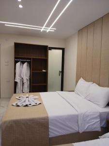 A bed or beds in a room at Inside Pyramids Hotel