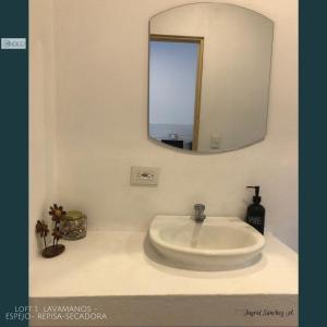 a white sink in a bathroom with a mirror at Hermoso apartamento tipo loft in Nicoya +17 photos