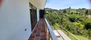 a balcony with a view of the forest at Villa Maru in El Peñol