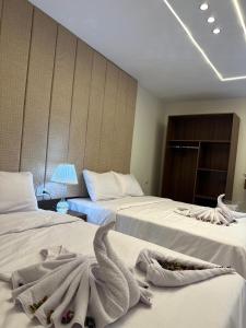 A bed or beds in a room at Inside Pyramids Hotel