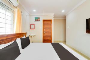 a bedroom with a bed and a window and a television at Hotel O S P R Luxury Rooms in Hyderabad +26 photos