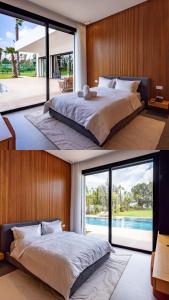 une chambre avec un grand lit et une grande fenêtre dans l'établissement Villa l'Hermitage, à Oulad Mbark