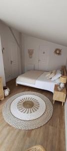 a bedroom with a bed and a large rug on the floor at La Cabane Bohème, Maison d'hôtes Bassin d'Arcachon in Gujan-Mestras +46 photos