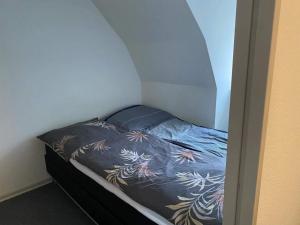 a small bed in a corner of a room at 2 person holiday home in Ringkøbing in Ringkøbing