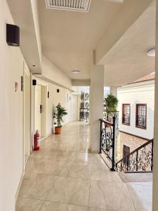 a hallway of a building with a staircase with potted plants at Adria Inn in Antalya