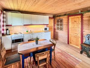 a kitchen with a table and chairs in a cabin at 4 person holiday home in gol in Gol