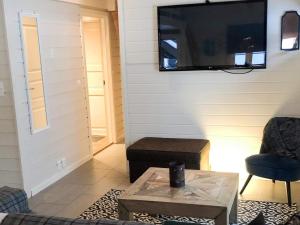 a living room with a tv on a wall at 8 person holiday home in Hemsedal in Hemsedal