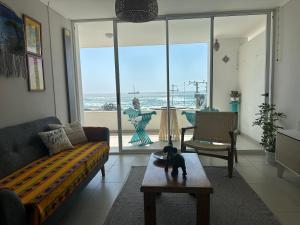 a living room with a dog sitting on a coffee table at Espectacular Depto frente al mar in Arica