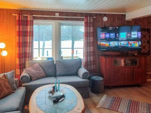 a living room with a couch and a flat screen tv at 6 person holiday home in Gratangen in Gratangen