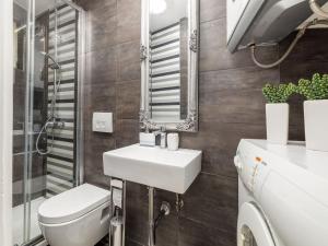 a bathroom with a sink and a toilet and a mirror at House in Fa ana near Rock Beach in Fažana +32 photos
