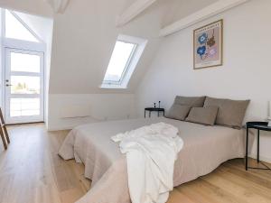 a white bedroom with a bed and a window at 5 star holiday home in Liseleje in Liseleje