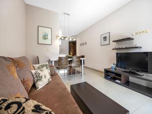 a living room with a couch and a flat screen tv at Jacuzzi Retreat in Banjol in Banjol
