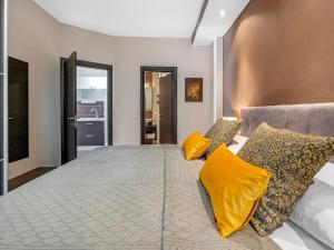 a bedroom with a large bed with yellow pillows at Jacuzzi Retreat in Banjol in Banjol +32 photos