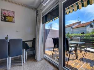 a room with a balcony with a table and chairs at Apartment in Fa ana near Rock Beach in Valbandon