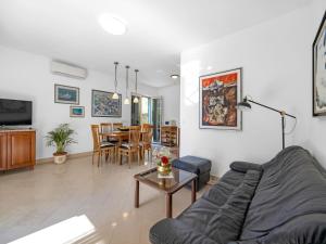 a living room with a couch and a table at Tranquil Escape in Banjol in Banjol