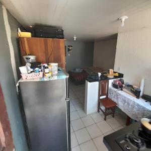 a kitchen with a stainless steel refrigerator in a room at São bras casa in Belém