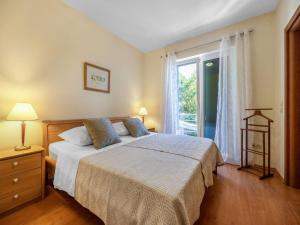 a bedroom with a bed and a large window at Apartment near Rab Beach in Banjol +32 photos