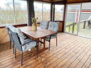 a dining room with a wooden table and chairs at 4 person holiday home in FäRJESTADEN in Färjestaden