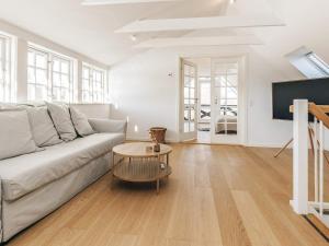 a living room with a couch and a table at 5 star holiday home in Liseleje in Liseleje