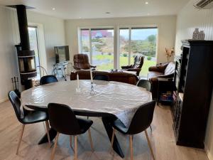 a living room with a table and chairs at 4 star holiday home in Tjeldstø in Tjeldstø +37 photos