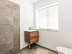 a bathroom with a sink and a toilet and a window at 5 star holiday home in Liseleje in Liseleje +35 photos