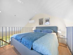 a bedroom with a bed with blue sheets and a balcony at Apartment with Garden, Banjol in Banjol +32 photos