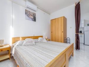 a bedroom with a large bed with a wooden frame at Studio in Valbandon near Brijuni National Park in Valbandon
