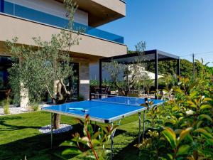 a blue ping pong table in front of a building at Villa in Marcana with Pool near Brijuni Park in Marčana