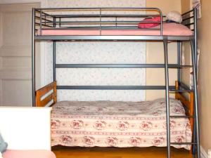 two bunk beds in a room with a bed at 4 star holiday home in UDDEVALLA in Fiskebäckskil