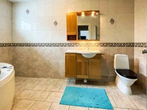 a bathroom with a sink and a toilet and a mirror at 8 person holiday home in Ruda in Ruda +28 photos