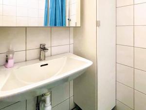 a bathroom with a white sink and a mirror at 4 star holiday home in FRÄNDEFORS in Frändefors +31 photos