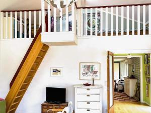 a living room with a staircase and a television at 4 star holiday home in FRÄNDEFORS in Frändefors