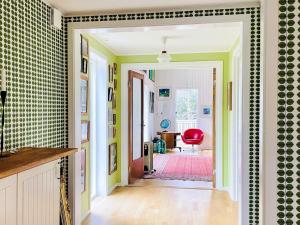 a hallway with green walls and a red chair at 4 star holiday home in FRÄNDEFORS in Frändefors