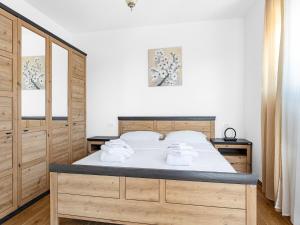 a bedroom with a bed with towels on it at Villa in Krnica with Pool near Rock Beach in Krnica +37 photos