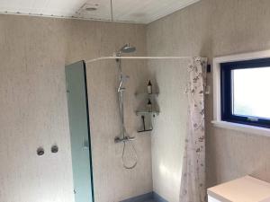 a bathroom with a shower with a shower curtain at 8 person holiday home in Nakskov in Nakskov +36 photos