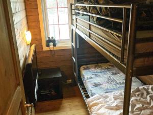 a small room with a bunk bed and a window at 6 person holiday home in lyngdal in Lyngdal