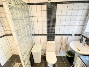 a bathroom with a toilet and a sink at 4 person holiday home in ANDERSLÖV in Anderslöv +37 photos