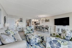 a living room with couches and a dining room at G3 Amelia South condo in Fernandina Beach