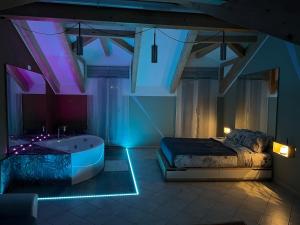 a bedroom with a tub and a bed with lights at Jacuzzi Turin Center - Serendipity Suite in Turin