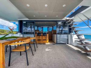 a room with a table and a staircase on a yacht at bateau in Les Trois-Îlets