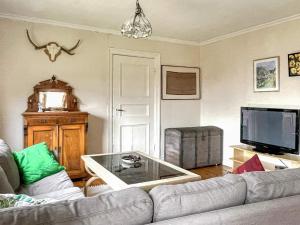 a living room with a couch and a glass coffee table at 4 star holiday home in UDDEVALLA in Fiskebäckskil