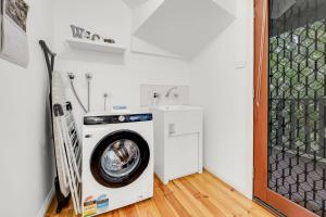 eine Waschmaschine in einer Waschküche mit Waschbecken in der Unterkunft The Gap in Bright