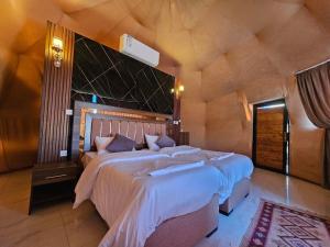a bedroom with a large bed in a room at Wadi Rum star in Wadi Rum