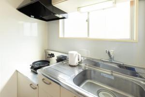 Η κουζίνα ή μικρή κουζίνα στο グリシーヌ警固 Apartment Hotel