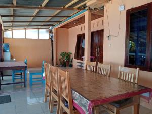 a dining room with a table and chairs at MAMALIS HOMESTAY in Manado