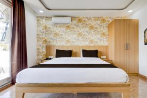 Postel nebo postele na pokoji v ubytování Super Hotel O Tasvi Stayz + 22 fotografií