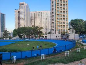 a circular park in a city with tall buildings at Belissímo in Brasília