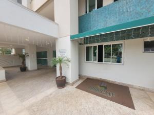 a large building with a palm tree in the courtyard at Belissímo in Brasília